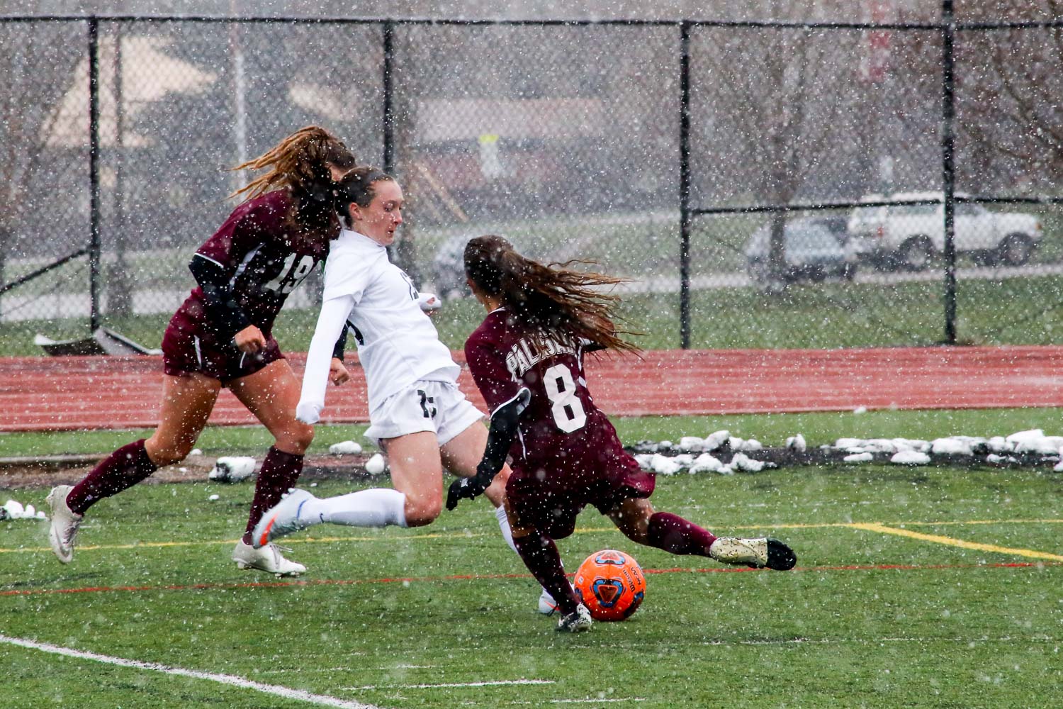 Kenzie Gansmann taking on two Palisade defenders in Steamboat's 2-0 win