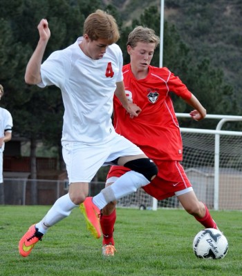 Glenwood Springs High School's Will Osier, left, battles for possession of the soccer ball with Will Beurskens, of Steamboat Springs, during the first half of a Class 4A Western Slope League soccer match at Stubler Memorial Field on Tuesday. The Sailors beat the Demons, 2-1.